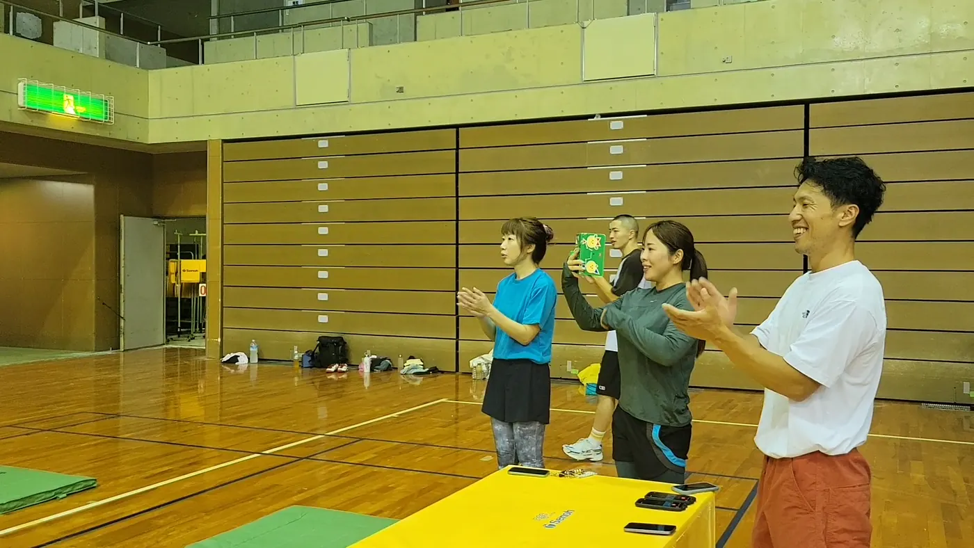 レッスン参加者が体育館で拍手している様子